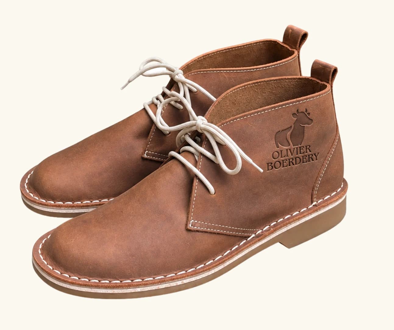 Tan leather chukka boot with the Olivier Boerdery farm logo debossed into the heel counter
