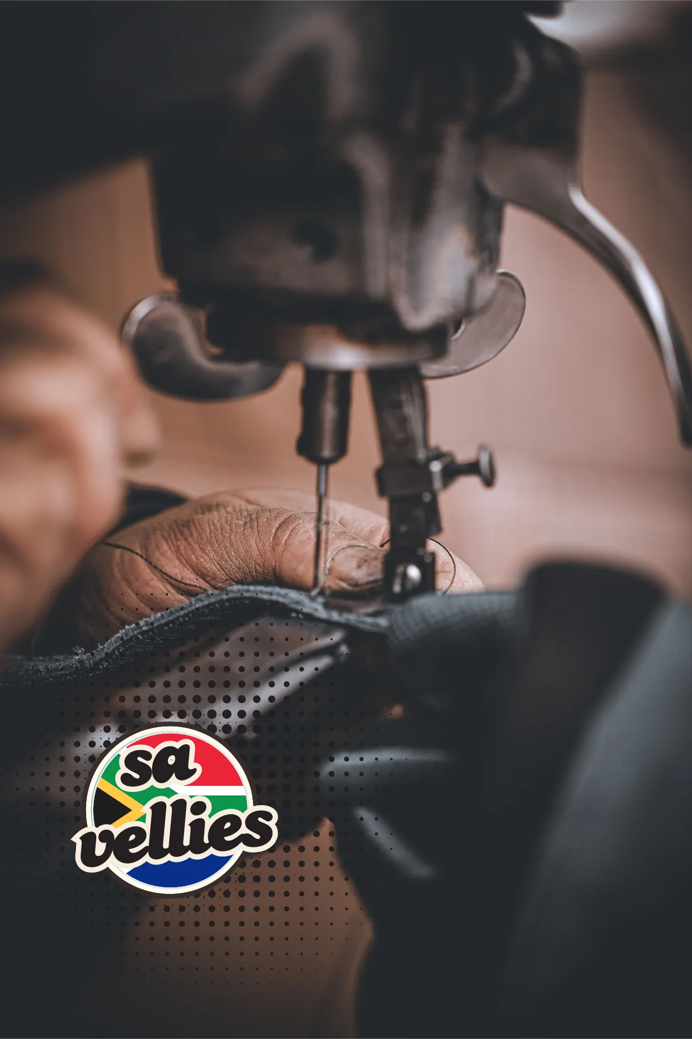 A maker's hands guiding leather under the needle of an industrial sewing machine in the workshop